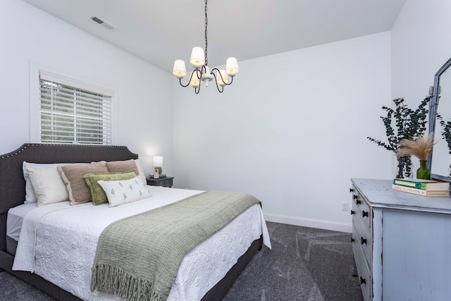 carpeted bedroom with an inviting chandelier