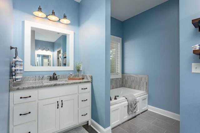 bathroom with tile patterned floors, vanity, and a bath