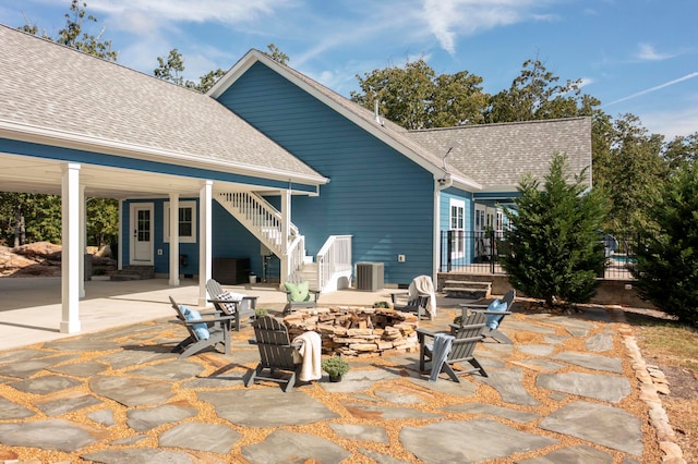 back of property featuring a patio and an outdoor fire pit