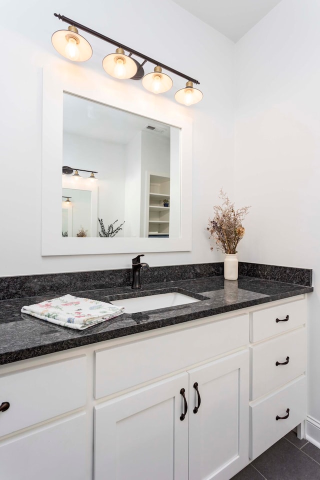 bathroom with tile patterned flooring and vanity