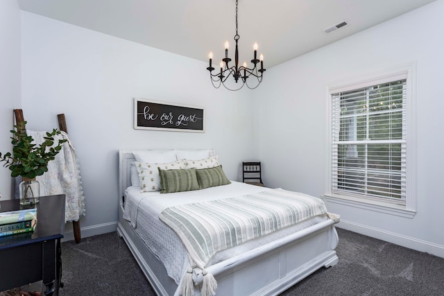 carpeted bedroom with a chandelier