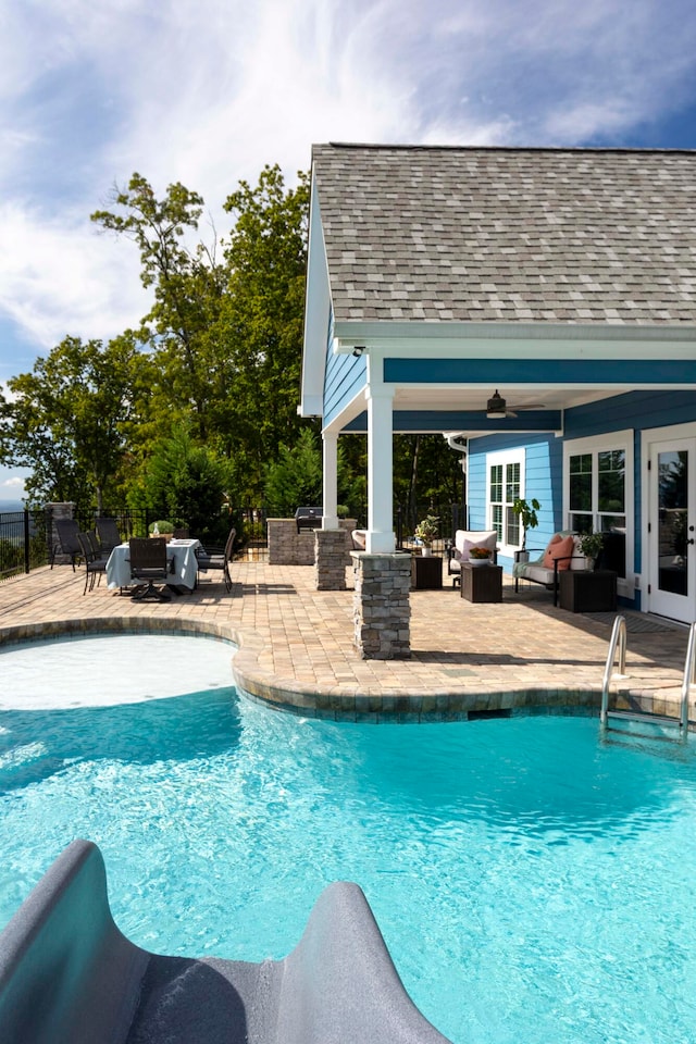 view of swimming pool featuring outdoor lounge area, ceiling fan, and a patio