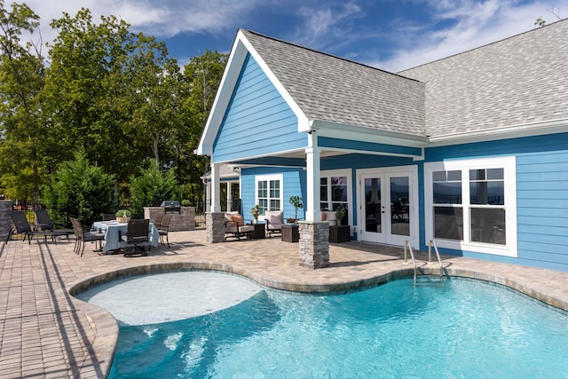 view of pool with outdoor lounge area, french doors, and a patio