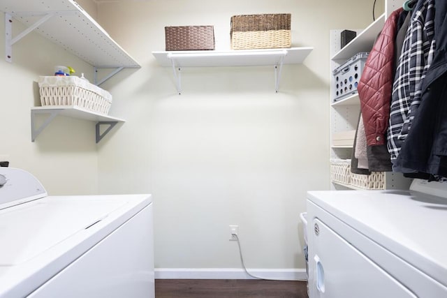 laundry area with washing machine and clothes dryer and dark hardwood / wood-style flooring