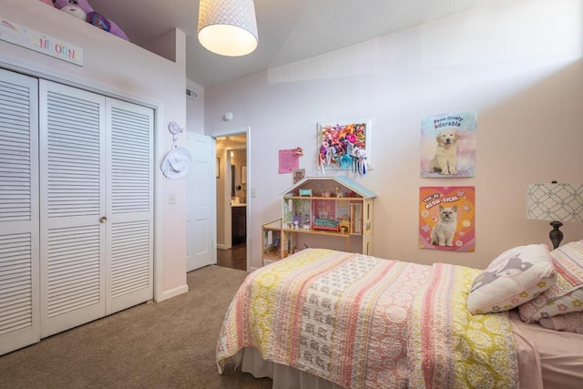 bedroom featuring lofted ceiling, a closet, and carpet