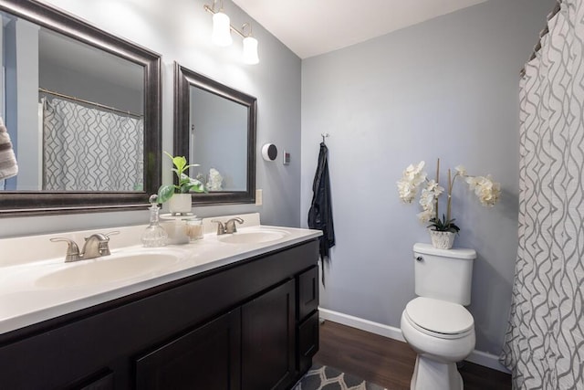 bathroom featuring vanity, hardwood / wood-style floors, and toilet