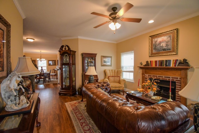 living room featuring dark hardwood / wood-style flooring, a brick fireplace, ceiling fan, and ornamental molding