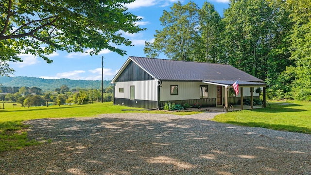 250 Creek Rd, Sweetwater, TN 37874 - view of front of house featuring a front lawn, a mountain view, metal roof, and gravel driveway