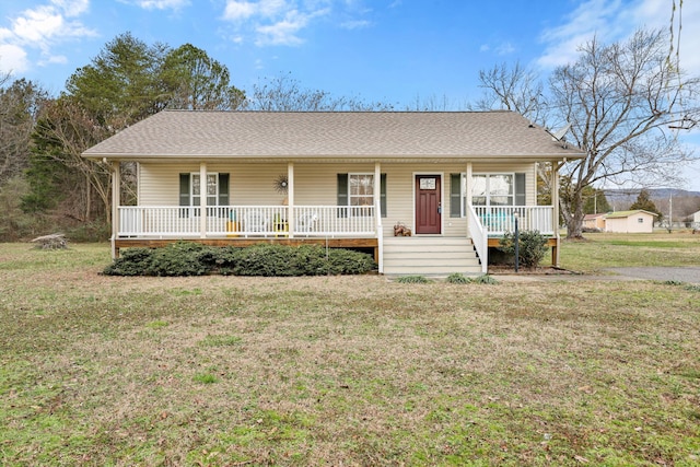 single story home featuring covered porch and a front yard