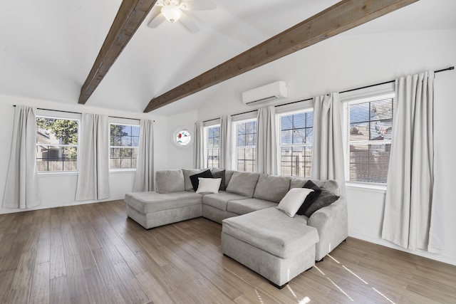 living area featuring a ceiling fan, a wall unit AC, vaulted ceiling with beams, and light wood finished floors