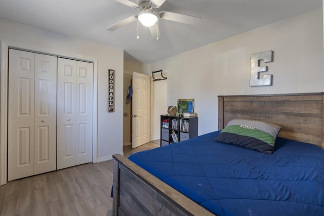 bedroom with ceiling fan, a closet, and wood finished floors