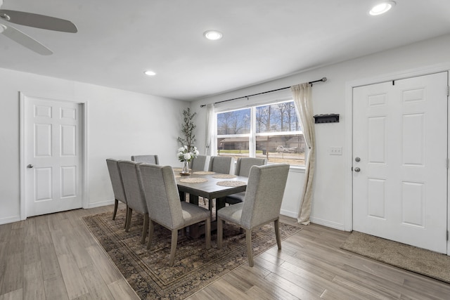 dining room with light wood finished floors, ceiling fan, baseboards, and recessed lighting