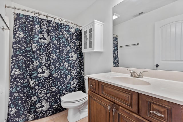 bathroom featuring tile patterned flooring, vanity, and toilet