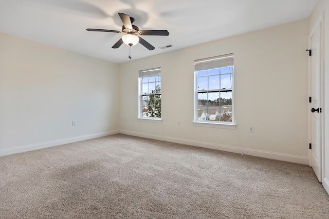 spare room with carpet floors and ceiling fan