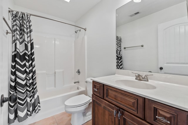 full bathroom featuring vanity, tile patterned floors, toilet, and shower / bath combo