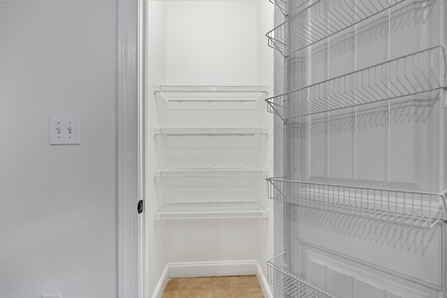 spacious closet with tile patterned floors