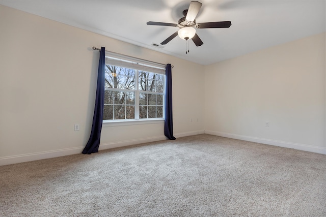 carpeted spare room with ceiling fan