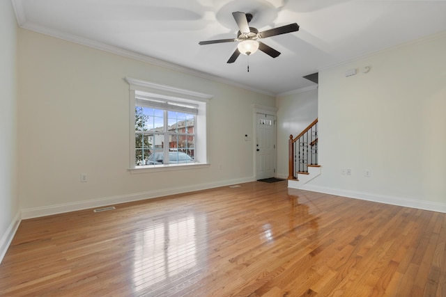 unfurnished living room with crown molding, ceiling fan, and light wood-type flooring