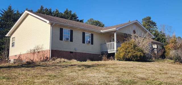 view of property exterior featuring a yard and covered porch