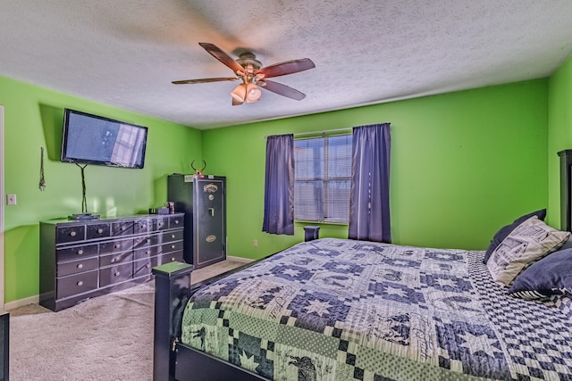 carpeted bedroom featuring baseboards, a textured ceiling, and a ceiling fan