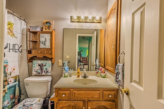 bathroom featuring toilet and vanity