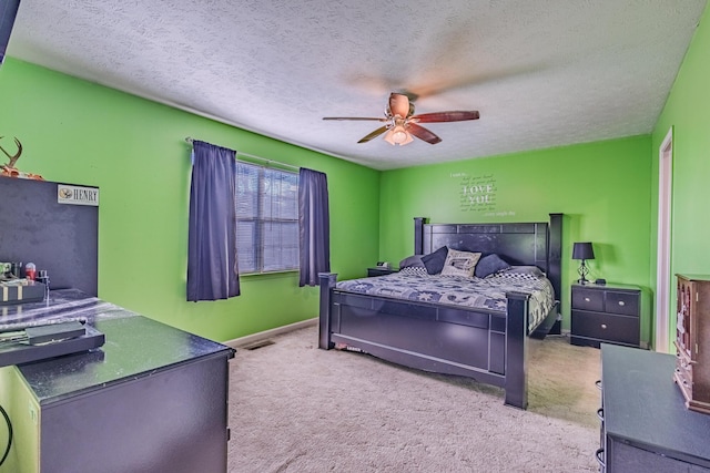 bedroom with carpet flooring, a ceiling fan, baseboards, and a textured ceiling