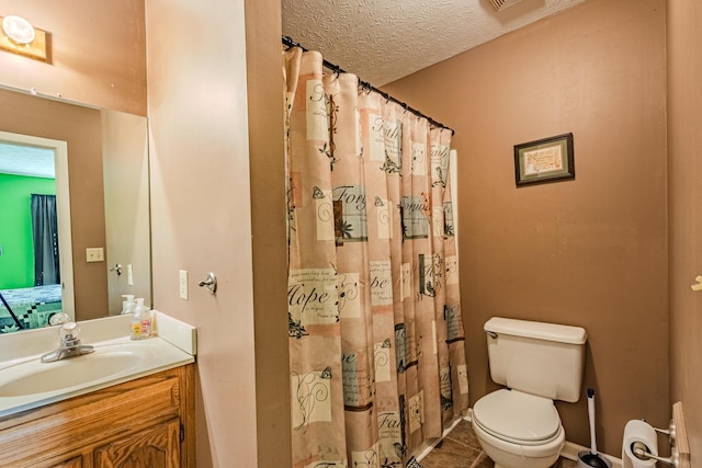 full bathroom with vanity, curtained shower, toilet, and a textured ceiling