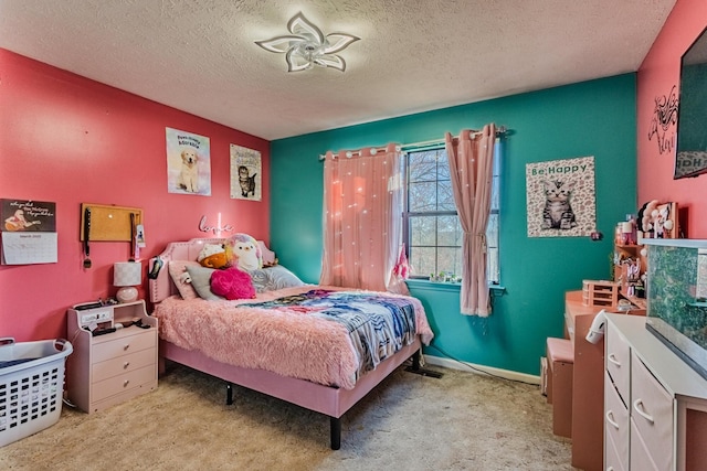 carpeted bedroom with baseboards and a textured ceiling