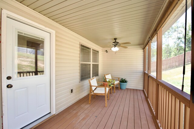 sunroom featuring a wealth of natural light, ceiling fan, and wood ceiling