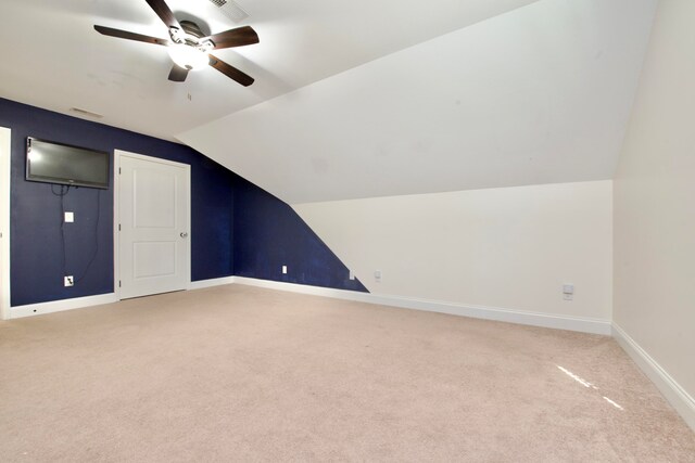 additional living space with carpet flooring, ceiling fan, and lofted ceiling