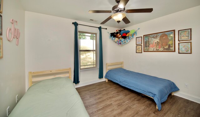 bedroom featuring dark hardwood / wood-style flooring and ceiling fan