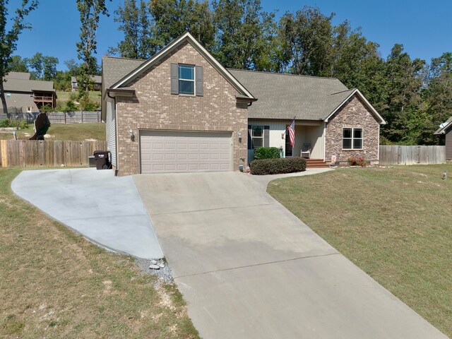 craftsman inspired home featuring a garage and a front lawn