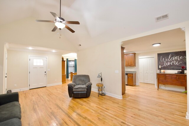 living room featuring ornamental molding, light hardwood / wood-style flooring, ceiling fan, and lofted ceiling