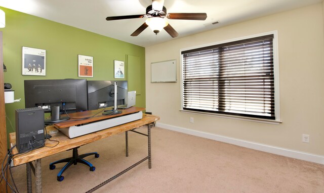 carpeted office space featuring ceiling fan