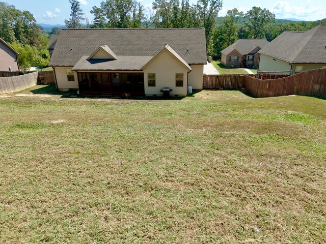 back of house featuring a sunroom and a yard