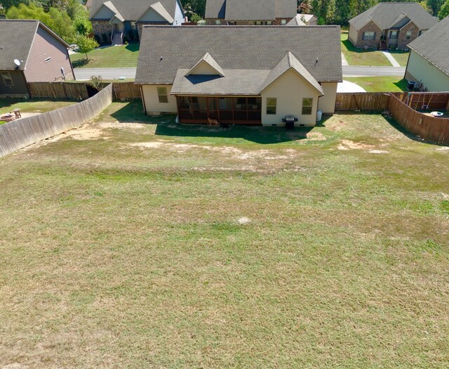 back of property with a sunroom