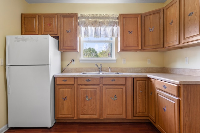 kitchen featuring sink, white fridge, and dark wood-type flooring