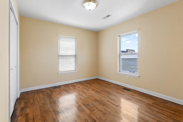 unfurnished bedroom featuring dark hardwood / wood-style flooring and a closet