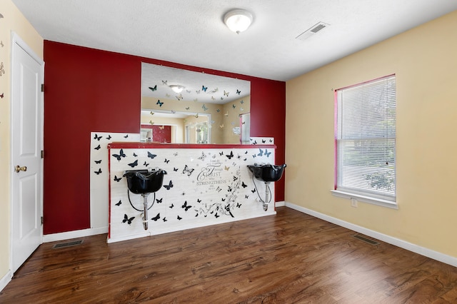 interior space featuring dark hardwood / wood-style flooring and a textured ceiling