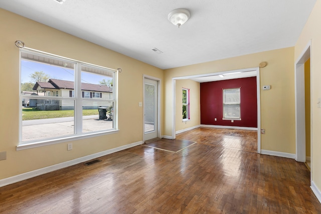 spare room featuring dark hardwood / wood-style floors