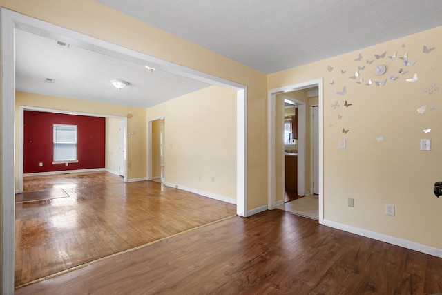 empty room featuring wood-type flooring