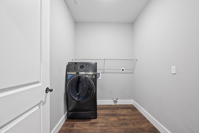 laundry area with dark hardwood / wood-style flooring and washer / clothes dryer