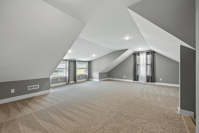 bonus room with carpet and lofted ceiling