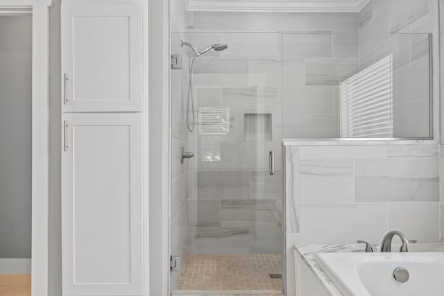 bathroom featuring shower with separate bathtub