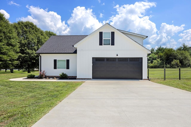 modern farmhouse style home featuring a front yard and a garage