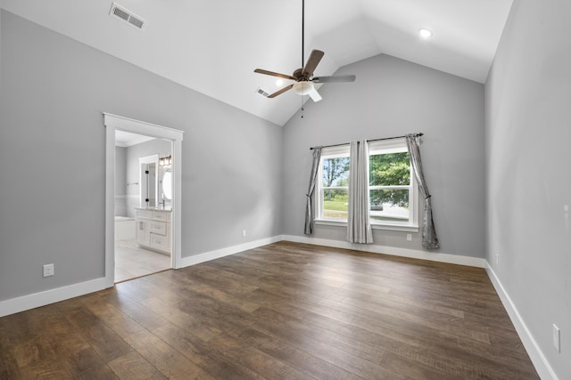 unfurnished bedroom featuring ensuite bathroom, high vaulted ceiling, hardwood / wood-style flooring, and ceiling fan