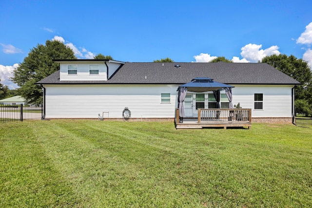 back of property with a gazebo, a yard, and a deck