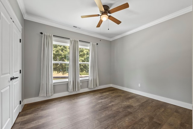 spare room featuring ceiling fan, ornamental molding, and dark wood-type flooring