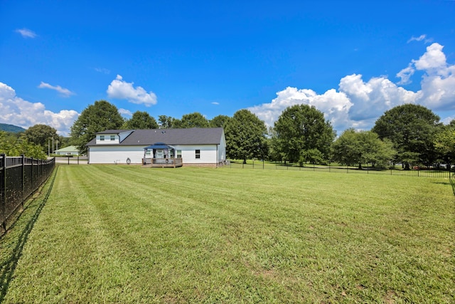 view of yard with a rural view and a deck