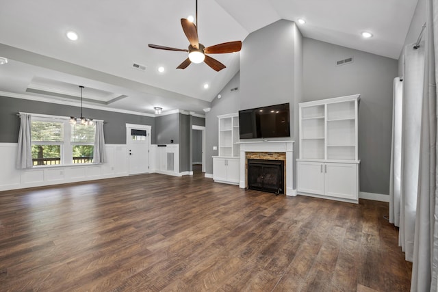 unfurnished living room featuring ceiling fan with notable chandelier, dark wood-type flooring, high vaulted ceiling, and ornamental molding